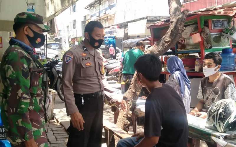 Bhabinkamtibmas Butung dan Babinsa Ajak Warga Disiplin Protokol Kesehatan
